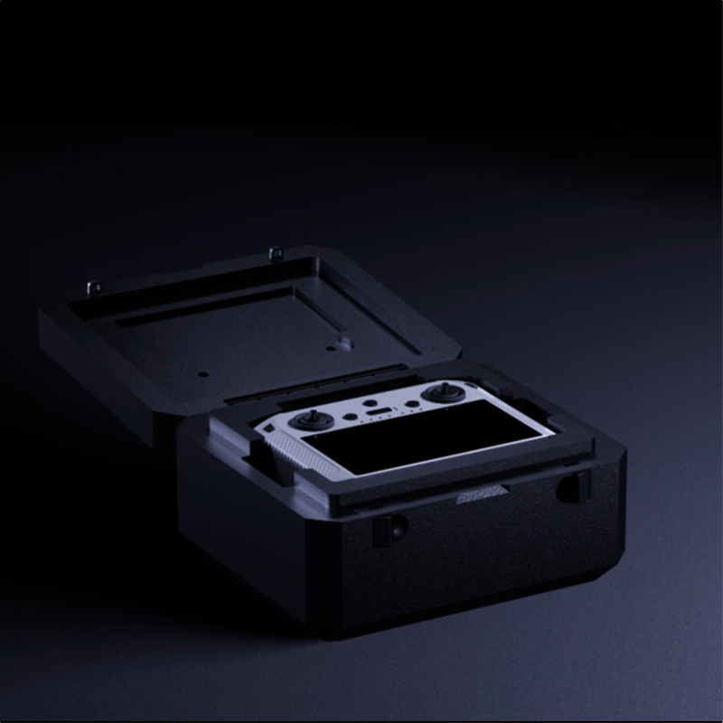 silver remote controller for gimbal camera on drones in a black box in a dark setting